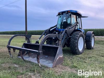 2005 New Holland TV145 Bi-Directional MFWD Tractor w/7614 Loader & Grapple