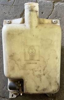 Windshield washer fluid reservoir with mounting bracket. Cap is missing from the