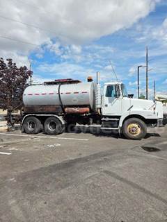 1996 Etnyre/Volvo Model S2000 Black Topper Distributor Truck
