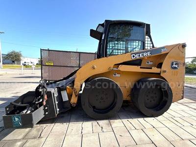 JOHN DEERE SKID STEER MODEL 315, DIESEL, ENCLOSED CAB , UNUSED ROLLER ATTACHMENT, SMOOTH TIRES, RUNS AND OPERATES
